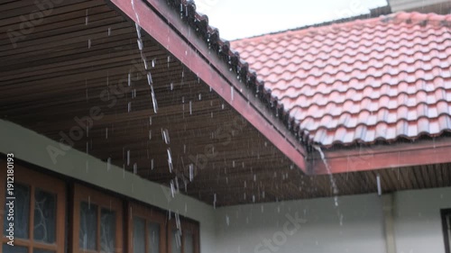 Wallpaper Mural The roof of a house is covered in rain. The rain is falling in a steady stream, and the roof is leaking Torontodigital.ca