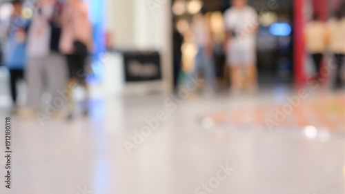 Wallpaper Mural A blurry image of a crowded mall with people walking around. Scene is busy and bustling, with people going about their day Torontodigital.ca