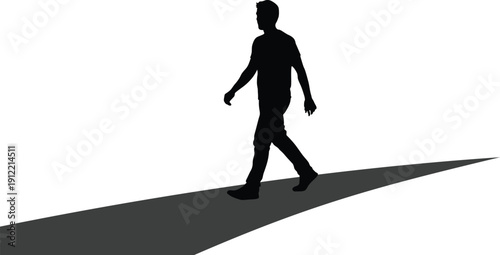 A person walking with a long shadow behind them