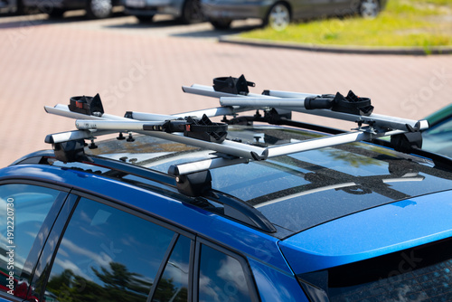 Photos Car roof rack with crossbars and mounting brackets installed on a blue vehicle p