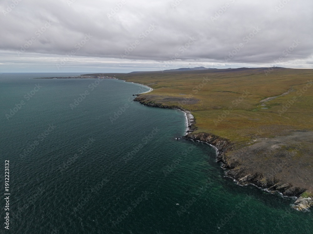 Obraz premium Aerial view showing vast Chukotka subarctic wilderness with dramatic coastal terrain and pristine nature displaying exploration potential for travel photographers and all adventurers