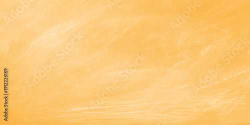 An old grunge paper texture with yellow flowers rests on a brown weathered oak wood grain surface featuring a natural timber plank pattern