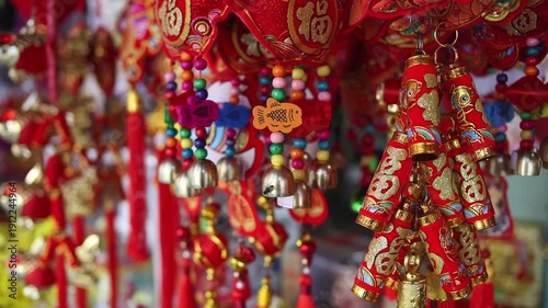 Colorful red and golden decorative elements sold on an vietnamese street market prior to the Tet holiday or Lunar new year in Vietnam, Asia. Selective focus close up video.
