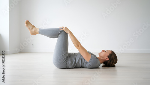 Woman in Happy Baby Pose for pelvic floor health in studio