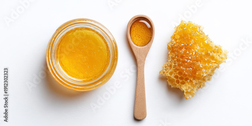 Wallpaper Mural Golden honey jar with honeycomb and wooden spoon on white background Torontodigital.ca