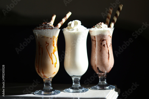 Canvas Print Delicious milkshakes or Blended Iced Coffee with whipped cream and wafer sticks