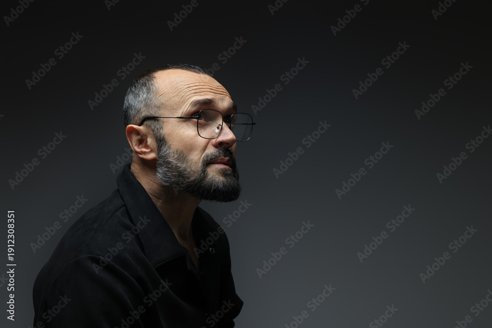 Fototapeta premium Fashion model. Handsome man in glasses on grey background, space for text