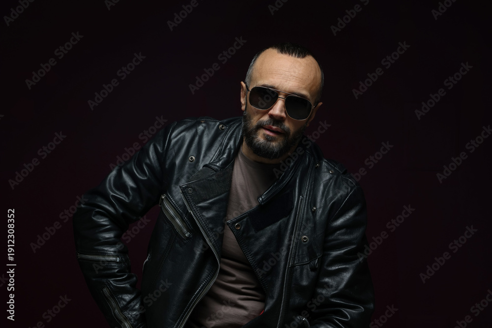 Obraz premium Fashion model. Handsome man in sunglasses on black background