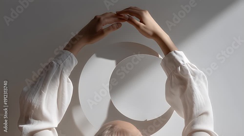 Woman's hands casting artistic shadow in soft natural light