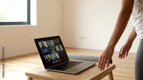 Woman closing laptop showing a video conference with people during a yoga session at home