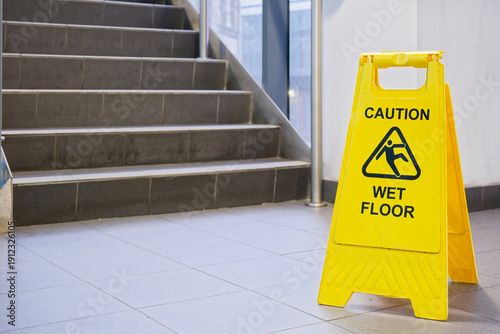 Caution wet floor cone safety notice at public stair