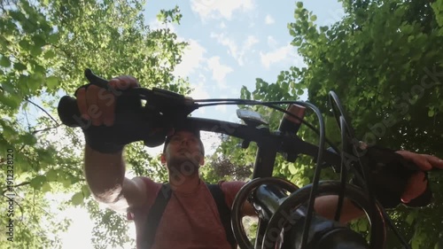Male cyclist rides mountain bike fast through forest trail with dynamic low angle view concept of adventure, adrenaline, freedom. Exercise healthy lifestyle outdoors weekend trip get away nature park