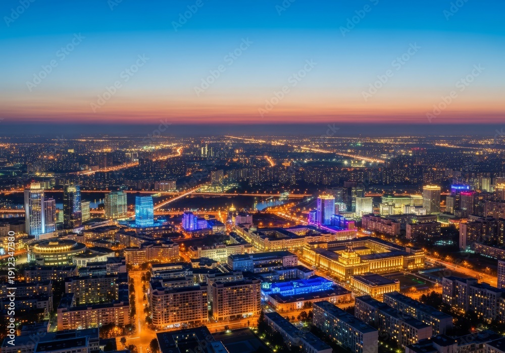 Obraz premium Ultra-wide cinematic view of a sprawling modern capital cityscape featuring illuminated cultural districts against a vast urban light horizon at twilight, structure, glass, development