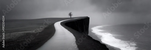 A winding road atop a cliff with ocean beside it. A solitary tree stands at the end, moody sky