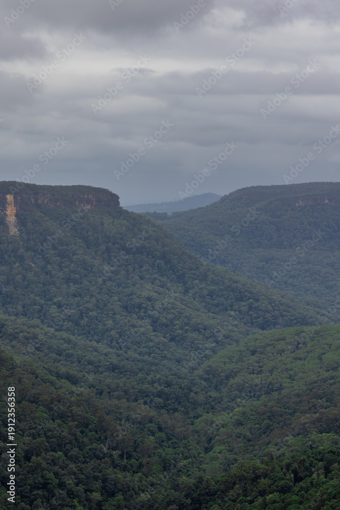Fototapeta premium Beautiful flowing River in Fitzroy water Falls in Bowral NSW Australia beautiful colourful cloudy skies lovely waterfalls