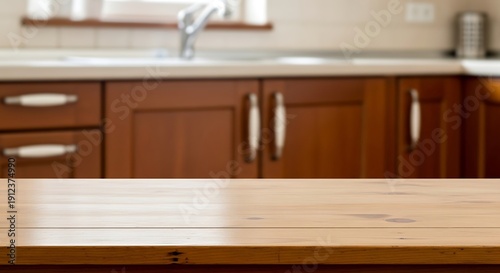 Light wooden surface against a blurred kitchen backdrop, interior view