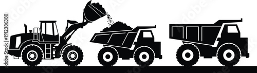 Wheel loader dumping soil into dump truck, heavy construction vehicles silhouette showing earthmoving equipment convoy on industrial worksite