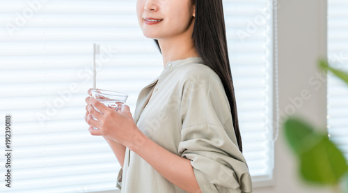 Photos Young Asian, Japanese woman brushing her teeth with a toothbrush at home (dental