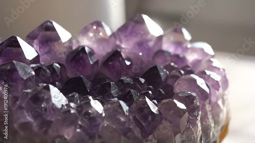 Close up Rotating View of a Natural Amethyst Geode Cluster with Sparkling Purple Crystals Catching the Light