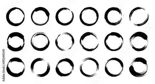 abstract black ink brushstroke circles forming zen enso symbols hand-drawn on white background ideal for spiritual and graphic design.