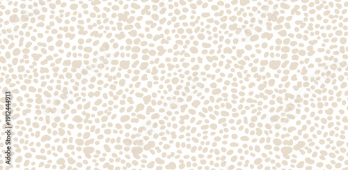 A close-up view of a spotted animal hide pattern, texture, and design on a natural surface