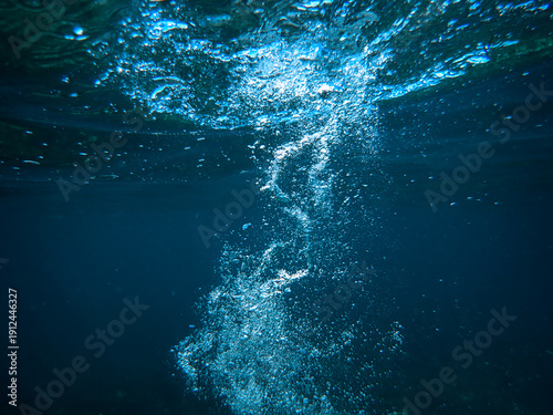Air bubbles underwater rising to water surface, natural scene, bubbles under water, bubble undersea, sea in crystal clear green water. Real image very suitable for backgrounds, Great for background.