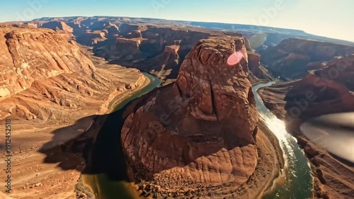 Cinematic aerial fpv drone footage over horseshoe bend in page arizona showing colorado river winding through red rock canyon wall