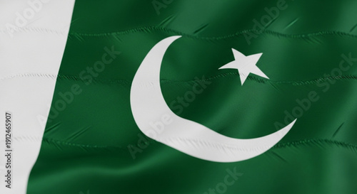 Pakistan flag waving with white crescent moon and star on green background symbolizing national pride and patriotism