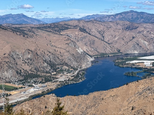 High Angle View of a Deep Blue Lake Winding Through Rugged Arid Mountains and Valley