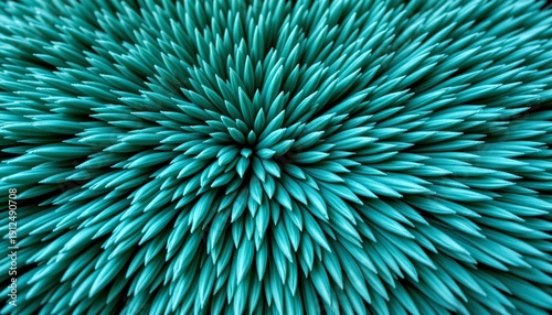 A close up of blue spikes arranged in a spherical pattern, with a partial view of a grey gradient background that suggests depth and contrast.