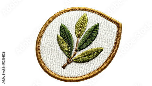 A close-up view presents an embroidered patch. It features a branch with leaves in varying shades of green, set against a white fabric