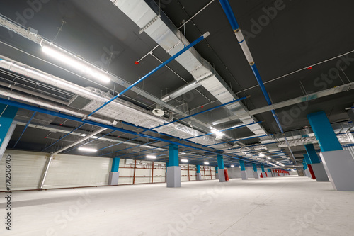 Spacious underground car park with modern lighting and wide open areas for vehicles