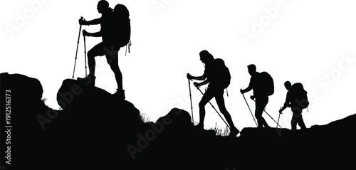 Silhouette of a group of four hikers with backpacks and trekking poles climbing a rocky mountain ridge during outdoor adventure exploration