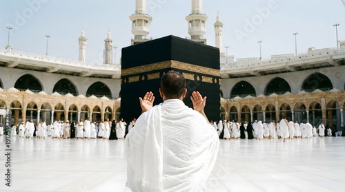 Muslim pilgrim in ihram raising hands in dua facing the Kaaba at Masjid al Haram, Mecca, capturing Hajj pilgrimage worship, Islamic faith devotion, and sacred holy mosque atmosphere.