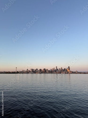 Seattle downtown skyline and waterfront at sunset, view from an approaching ferry on Elliott Bay.