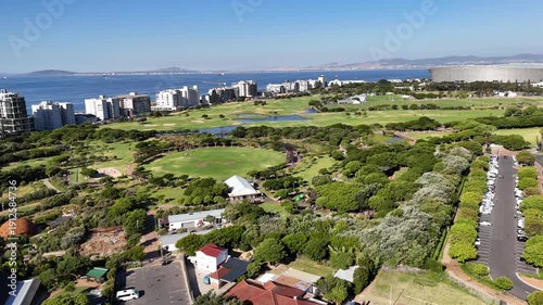 Drone orbits left around west side of Green Point Park on a sunny day in Cape Town, South Africa
