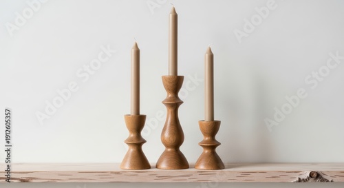 Elegant wooden candle holders showcasing minimalist design with three beige candles on textured shelf