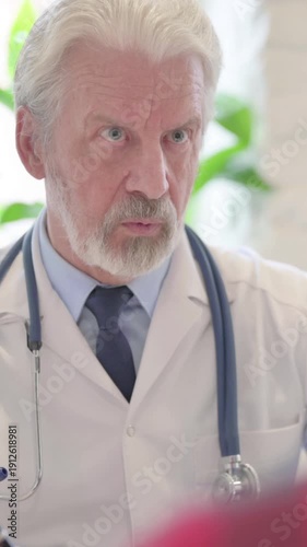 Close Up of Senior Doctor Talking with Patient in Clinic, vertical video
