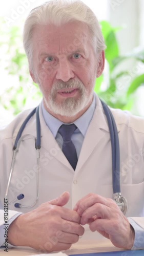 Blogging Senior Doctor Talking in Camera in Clinic, Video Chat, vertical video