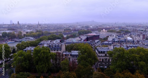 High angle view of Paris cityscape under overcast sky featuring Haussmann architecture