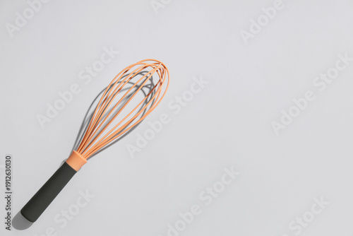 Modern whisk on grey backgr...