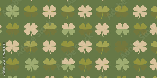 Stylized clover pattern featuring shamrocks in various shades of green on a solid green background viewed from directly above