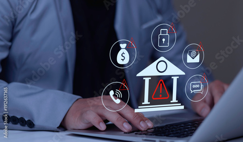 Quadro su tela Businessman typing on laptop with bank fraud warning hologram displaying red alert icons on money, email, and phone