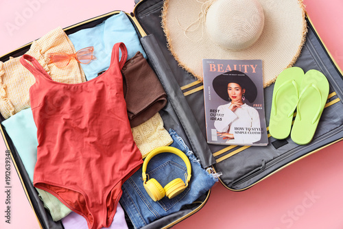 Open suitcase with beach ac...