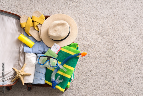 Open suitcase with clothes,...