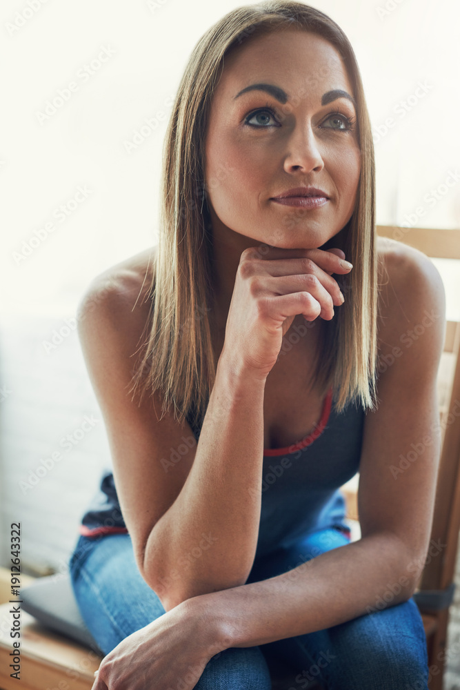 Naklejka premium Woman, happy and relax with thinking in home with decision, insight or inspiration in morning. Person, smile and perspective for reflection with memory, nostalgia or break in living room at apartment