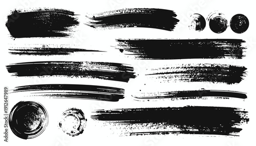 Collection of black brush strokes and paint splatters on a clean background from a close-up viewpoint