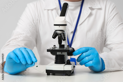 Male scientist with microsc...