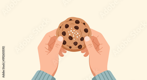 Two hands hold a chocolate chip cookie with sprinkles of salt