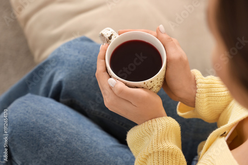 Young woman with cup of tea...